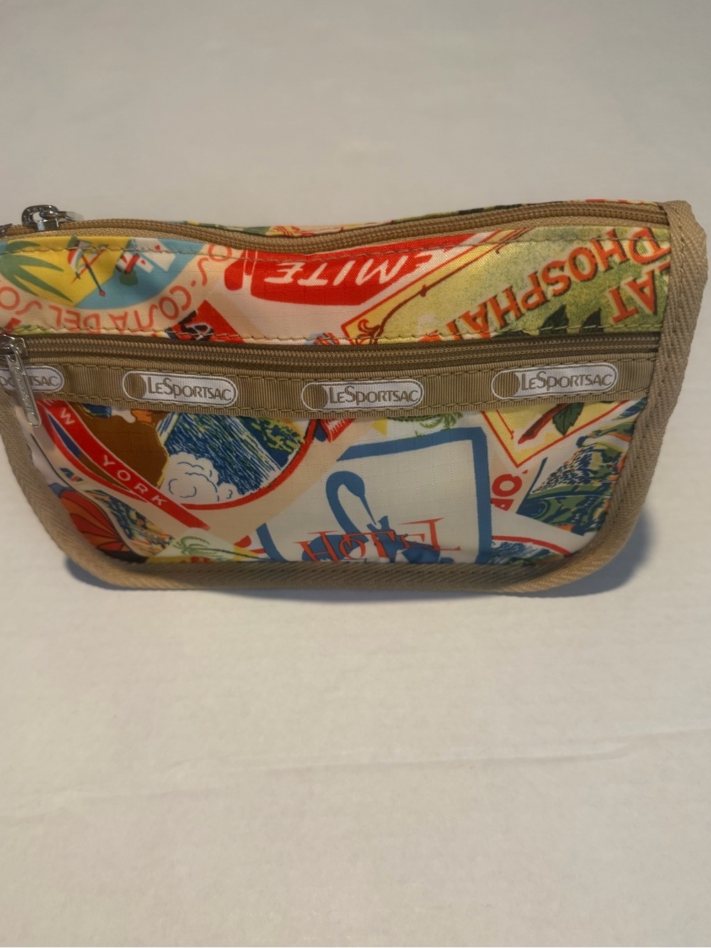 LeSportsac cosmetic bag-travel stamp pattern w/2 zippers. 7x5x3  never used